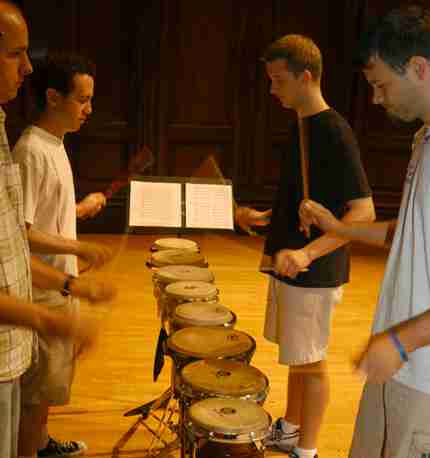 (From left) Joshua Hunt, graduate student, Sam Schmetterer, junior in FAA, Travis Knapp, sophomore in FAA, and Andrew Packer, graduate student, drum together in their percussion ensemble Wednesday at Smith Hall. Schmetterer says he wears earplugs because Ben Cleary
