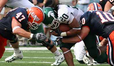 Illinois´ linebacker J. Leman (47) head butts Michigan State´s Jason Teague (20), while Illinois´ Kyle Kleckner (10) tackles him from behind during Illinois´ first Big Ten game on Saturday at Memorial Stadium. Illinois lost to Mich Josh Birnbaum
