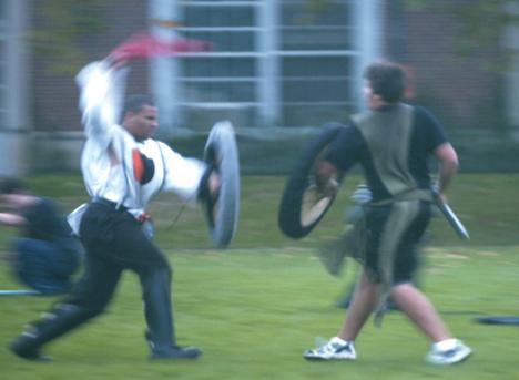Chris Harris (left), a graduate student, attacks Brian Thoman, freshman in ACES, during a meeting of Belegarth, an organization that recreates medieval battle techniques using foam weapons and shields Wednesday afternoon on the South quad. Alan Dodaro
