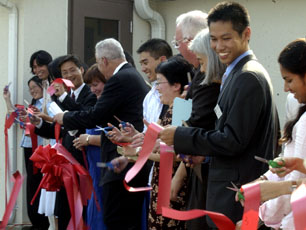 A red ribbon is cut to celebrate the grand opening of the Asian American Cultural Center Friday, Sept. 9, 2005. This center is connected to the Asian American Studies program house. The two organizations intend on working together to provide a place of co Tessa Pelias
