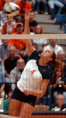 Middle blocker Megan Macdonald hits the ball over the net at the 22nd Annual State Farm Illini Classic against Eastern Illinois on Sept. 16 at Huff Hall. Illinois won 3-2. Tessa Pellas
