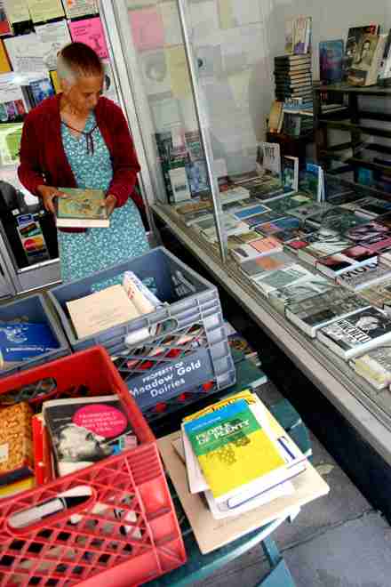 Urbana resident Joan Mills searches through crates of used books on Wednesday outside of Priceless Books at 108 W. Main St., Urbana. "You can find things at used book stores that just don´t exist anymore," Mills said. Regina Martinez
