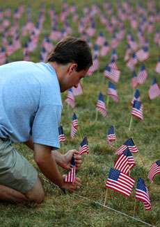 John Dodd plants flags at Cribbet Field on the corner of 4th Street and Pennsylvania Avenue early Sunday morning, September 11, 2005 as a part of the 9/11: Never Forget Project. A total of 3025 flags were planted, each representing a victim of the attack Austin Happel
