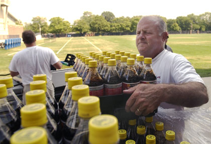 Coca-Cola employee Ed Condon, of Leroy, helps unload cases of beverages delivered to Memorial Stadium Wednesday. Josh Wilson, the Coca-Cola bulk driver, estimated that the Memorial Stadium order, in preparation for this weekend´s game, was approxim Dan McDonald

