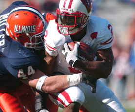 Illinois linebacker Brit Miller tackles Wisconsin´s Brian Calhoun during the first half of Saturday´s game at Memorial Stadium. Peter Hoffman
