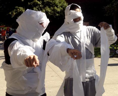 Tony Garcia and Gusiman Suarez, juniors in LAS, walk around wrapped in toilet paper and act like mummies Friday afternoon on the Quad. Tessa Pelias
