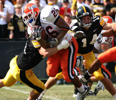 Illinois running back E.B. Halsey is tackled by Iowa defenders Saturday. Illinois lost, 35-7. Troy Stanger
