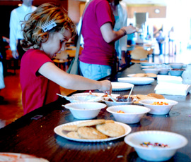 Piper Gouliard, 5, samples desserts from the food table at the Krannert Center on Saturday. The Taste of the Arts featured various performers and sweets. Peter Hoffman

