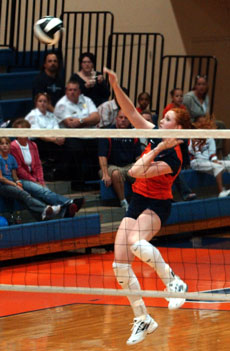Meghan Macdonald (4) and Rachel VanMeter (15) jump to block the ball hit by Sheila Shaw (17) at Huff Hall on Saturday. Illinois lost to Wisconsin, 3-0. Jamey Fenske
