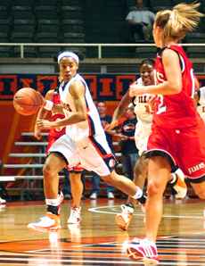 Illinois forward Janelle Hughes dribbles down the court while being guarded by a Lewis defender during the Illinois vs. Lewis basketball game Nov. 13, at Assembly Hall. Tessa Pelias
