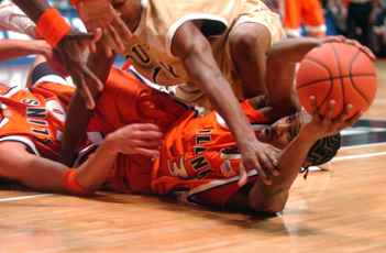 Illinois guard Chester Frazier (3) and forward James Augstine (40) fight aginst Qunicy´s Andre Muse (1) for the ball during the basketball game on Wednesday night at Assembly Hall. Illinois defeated Quincy, 78-52. Tessa Pelias
