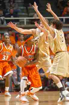 Illinois´ Dee Brown is guarded by Quincy´s Marcus Medsker (2) and Bryan Feldner (5) in Wednesday´s game at Assembly Hall. Adam Nekola
