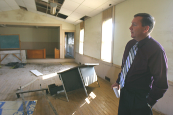 Peoria Chief John Froman stands in the schoolhouse where tribe members were educated for almost a century. The tribe recently purchased the building and is planning to restore it in order to open it for use by school groups. Josh Birnbaum

