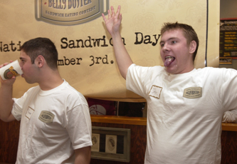 John Volk, senior in Engineering, displays his empty mouth as Theodore Cohen, freshman in LAS, drinks water at the end of Potbelly´s sandwich-eating contest at Potbelly´s on Fifth and Green streets Thursday. Volk, the winner of the competition Ben Cleary

