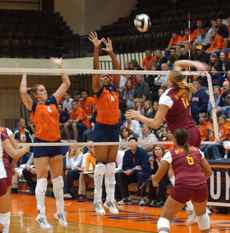 Minnesota´s Kyla Roehrig spikes the ball during the first of four games while Illinois players Kayani Turner (right) and Meghan Macdonald go for the block at Huff Hall on Oct. 16. Illinois lost the game 30-27 and the match three games to one. Peter Hoffman
