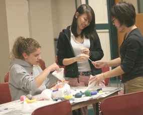 Emily Henkels, freshman in LAS, Dianna Xu and Rose Yaguchi, freshman in Business, fill balloons with flour to make stress balls during Avalanche´s Rest and Relaxation event held in Peabody Tunnels on Saturday. In light of all the mess, It´s Adam Babcock
