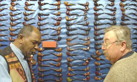 Rodney George Peacock and Jerry Moore discuss the new line of Christmas cigars they just received at John´s Pipe Shop in Champaign on Thursday afternoon. Amelia Moore
