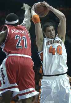 Arizona´s Hassan Adams (21) swipes at the ball held by Illinois´ James Augustine March 26 at the Allstate Arena in Rosemont, Ill. Illinois won 90-89 in overtime to reach the Final Four. Daily Illini file photo
