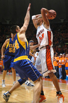 Illinois´ James Augustine looks to pass while being guarded by South Dakota State´s Michael Loney in the first half of the Nov. 18 game at Assembly Hall. Augustine had 18 points in Illinois´ season opener, which they won, 90-65. Adam Nekola
