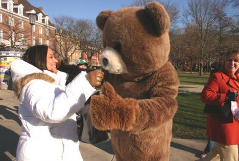 Donna Zimmerman (left), staff clerk in the LAS Dean´s Office, goes in for a hug Wednesday with Stu Schaff, senior in Business and member of the Office of Volunteer Programs. Schaff dressed as a teddy bear and walked the quad to help get the word out Regina Martinez
