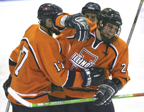 Illinois teammates celebrate with Nick Fabbrini after he scored the first goal in the second period of the hockey game at the Ice Arena on Saturday. Illinois defeated Michigan, 11-3, bringing their season record to 18-0. Josh Birnbaum
