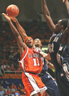 Illinois´ Dee Brown shoots the ball over Georgetown defenders in the game Thursday at Assembly Hall. Brown scored 16 points, helping Illinois to a win, 58-48. Josh Birnbaum
