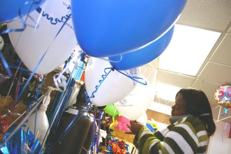 Taquisha Dorsey of Urbana works on a balloon arrangement Wednesday at Balloon Creations at 202 W. University Ave., Urbana. Dorsey said they will soon start making a lot of Christmas arrangements. Regina Martinez
