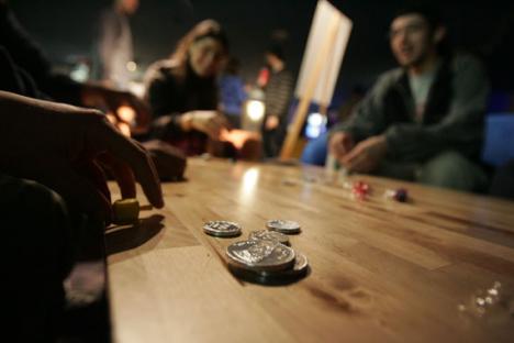 Students play in a dreidel competition in the basement of the Union on Thursday night as part of Chabad´s second annual Chanukah Bowl. The pre-holiday event featured billiards, bowling, raffles, menorah lighting, Israeli music, and latkes. Josh Birnbaum
