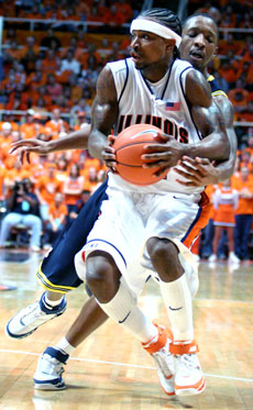 Michigan guard Daniel Horton (4) goes for the ball as Illinois guard Dee Brown (11) tries to lay it up against Michigan at Assembly Hall on Saturday. Brown went 6 for 17 and contributed 26 points to the 79-74 Illinois victory. Adam Babcock
