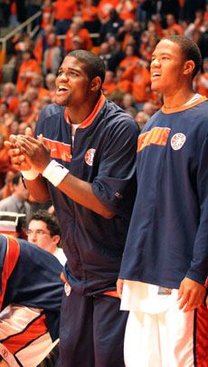 C.J. Jackson, left, and Chris Hicks, right, cheer on the team from the bench during the game against Michigan on Saturday. Illinois beat Michigan 79-74. Josh Birnbaum
