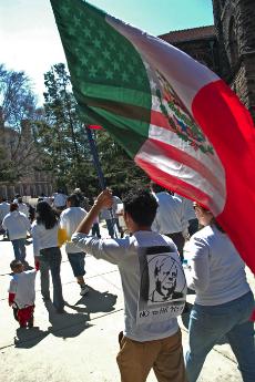 Protesters carry American and Mexican flags to the Quad in support of immigration reform Monday. Supporters marched from Neil Street down Green Street against bill HR-4437 that would make aiding an undocumented immigrant a felony. Beck Diefenbach
