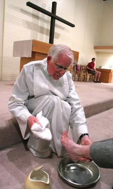 Reverend John Setterlund, Pastor of Saint Andrews Chruch at 909 S. Wright St., performs the washing of feet ritual on congregant Marian Baderschneider during Maundy Thursday Liturgy services. This is the one night of the year we observe the practice of Josh Birnbaum
