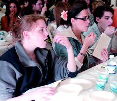From left, Julie Fry, freshman in LAS, Sami Weiss, freshman in ACES, and Geoff Nykin, freshman in LAS, participate in a quickie seder for Passover at Hillel on Wednesday. Suzanne Stelmasek
