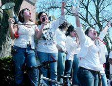 From left, Nayeli Fernandez, Cindy SanMiguel and Sonia Rodriguez, all sophomores in LAS lead members of the community in a protest against the new HR-4437 immigration bill that is currently before Congress. The protesters marched down Green Street from Ne Patrick Traylor
