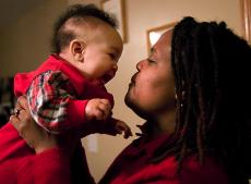 Toia Jones of Bolingbrook, Ill., plays with her 5-month-old son James at her home in Bolingbrook, Ill., Feb. 15. Associated Press
