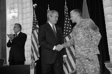 President Bush, left, shakes hands with U.S. Army General George Casey, before Bush spoke at the U.S. Embassy on Tuesday in Baghdad. Associated Press
