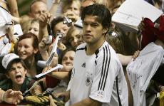 German soccer fans cheer as Michael Ballack finishes signing autographs in front of the Hotel Grunewald in Berlin on June 28. Ballack has become a symbol of united Germany. The Associated Press
