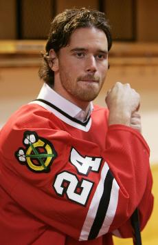 New Chicago Blackhawks forward Martin Havlat poses in his jersey after being formally introduced at a news conference in Chicago on Tuesday. Havlat was acquired from the Ottawa Senators in a three-team trade that also involved the San Jose Sharks. The Associated Press
