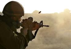 A soldier from the Israeli Army Golani Infantry Brigade fires his weapon at a firing range during training at a base near Kibbutz Zikim just outside the Gaza Strip on Tuesday. Israeli leaders ordered new incursions into the Gaza Strip, security officials The Associated Press
