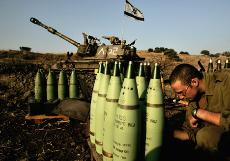 An Israeli gunner adjusts shells at a heavy artillery piece fires before firing on a target in southern Lebanon, near Kiryat Shmona, on the Israeli border Sunday. Lebanese guerrillas fired a relentless barrage of rockets into the northern Israeli city of The Associated Press
