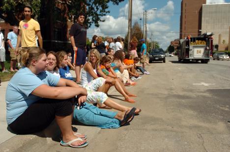 From left to right, Casey Meyer, Junior in Communications, Sharlene Blindt, Junior in ALS, Rachel Edgerle, Freshman in ALS, Emily Edgerle, Junior in Education, and Karrie Teske, Freshman in FAA, sit on the curb after being evacuated from their dorm rooms Beck Diefenbach
