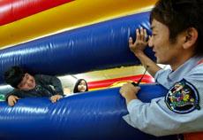 A kid reacts toadvice from Hiroaki Tokumura, right, a staff at the Fantasy Kids Resort in Ebina, west of Tokyo, March 28. The Associated Press

