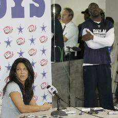 Dallas Cowboys wide receiver Terrell Owens, right rear, looks on as his publicist Kim Etheredge responds to a question during a press conference at the Cowboys training facility in Irving, Texas, Wednesday. Tim Sharp, The Associated Press

