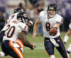 Chicago Bears quarterback Rex Grossman (8) hands off the ball to running back Thomas Jones (20) during the third quarter of an NFL football game against the Minnesota Vikings in Minneapolis Sunday. The Bears won 19-16. Ann Heisenfelt, The Associated Press
