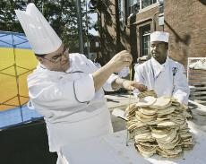 ohn Montanile, left, and Mark Williams, from the Cooking and Hospitality Institute of Chicago, measure a stack of pancakes as they try to build a record-setting stack, Tuesday. The attempt did not surpass 16 inches, which fell short of the 27 1/2 inch sta The Associated Press
