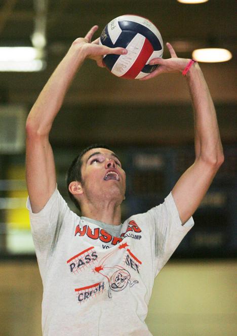 A student on the Illinois mens club volleyball team, sets the ball at practice in Kenney Gym Annex in Urbana.
