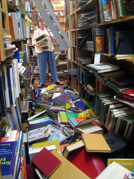 Jan Morgan of Hawi Town, Hawaii picks up some of the thousands of books that felt onto the floor of her book store in Kapaau, Hawaii Monday, Oct. 16, 2006, after Sunday's 6.6-magnitude earthquake that struck off the coast of the Big Island in Hawaii. No injuries were reported. (AP Photo/Agustin Tabares)
