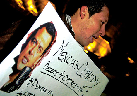 Eddie Roman, senior in LAS, protests the Carlos Mencia standup comedy show outside of Assembly Hall, Sunday evening. Roman tells attendants as they are walking in, Learn about your own culture before you laugh at it. Protesters were later invited by M Adam Babcock The Daily Illini
