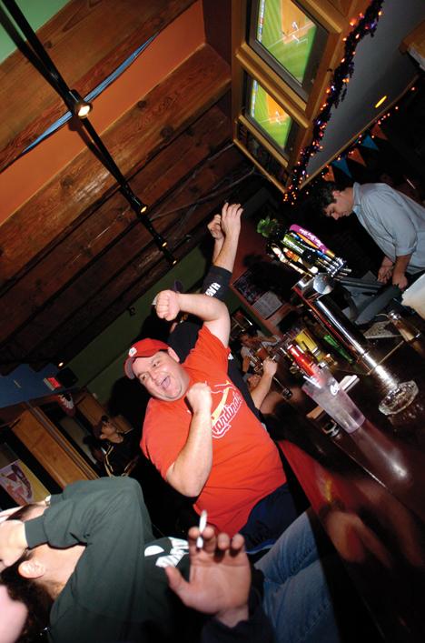 Beck Diefenbach The Daily Illini Cory Whitt, of Champaign, celebrates in Rock's Bar at 25 East Springfield in Champaign, after a throwing error by Tiger's pitcher Joel Zumaya allowed for the Cardinals to score in the seventh innning. The Cardinals beat the Tiger's 5 to 0.
