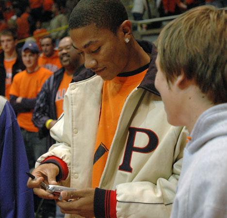 A recruit signs an autograph for a fan after the Orange and Blue Scrimmage at Assembly Hall, Friday October 27th, 2006. Potential recruits were invited to watch the scrimmage match on the floor of the court. Joseph Lamberson
